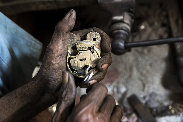 via Getty : A worker manufactures a lock at a workshop in Aligarh