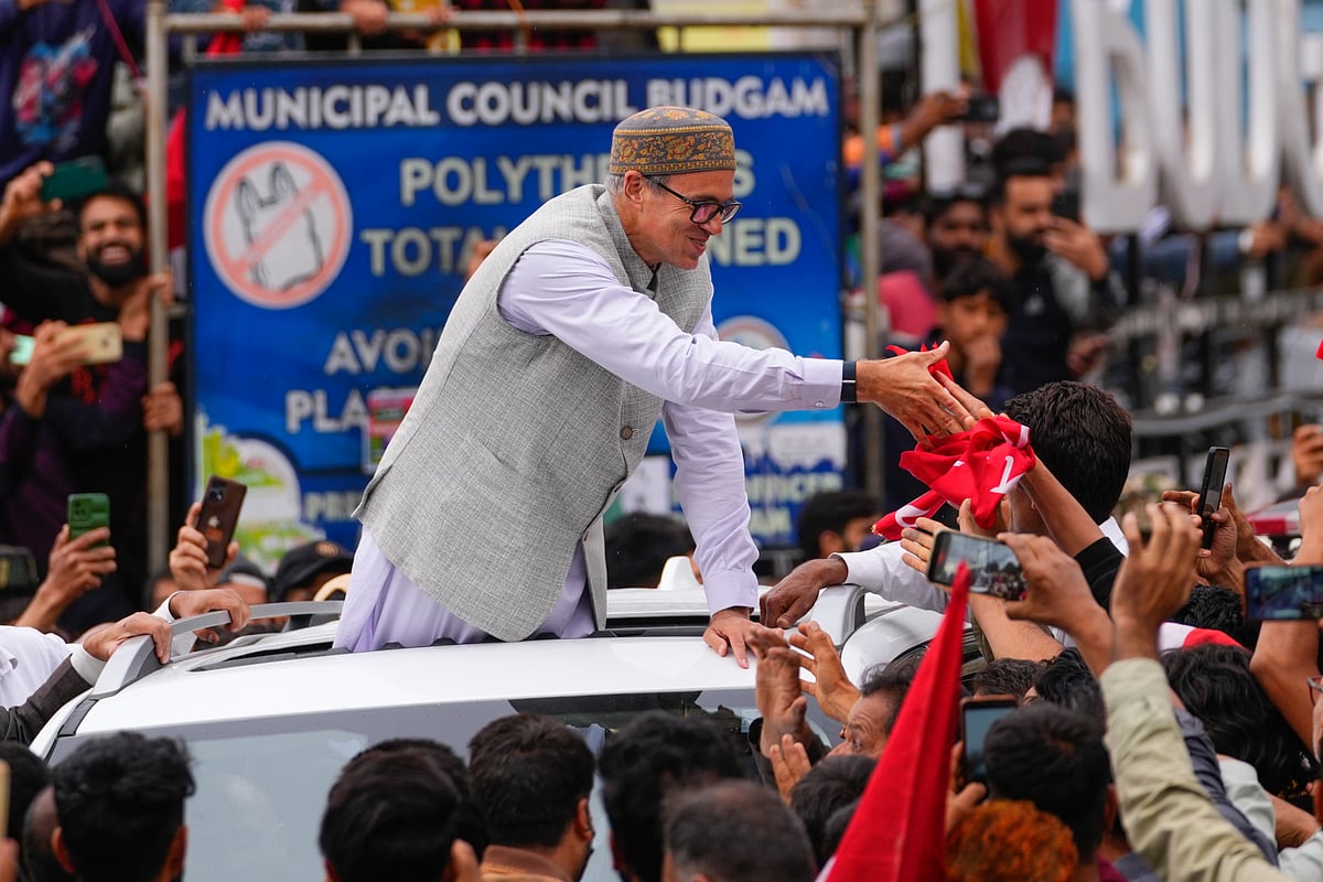 Dar Yasin via AP : Jammu and Kashmir National Conference (JKNC) party leader Omar Abdullah, standing on car shakes hands with supporters as he celebrates his victory in the election in Budgam on Tuesday.