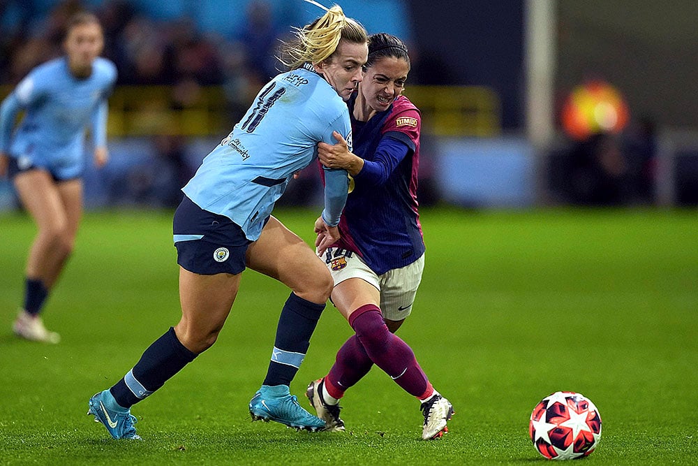 | Photo: Martin Rickett/PA via AP : Womens Champions League: Manchester Citys Lauren Hemp, left, and Barcelonas Aitana Bonmati, right, challenge for the ball 