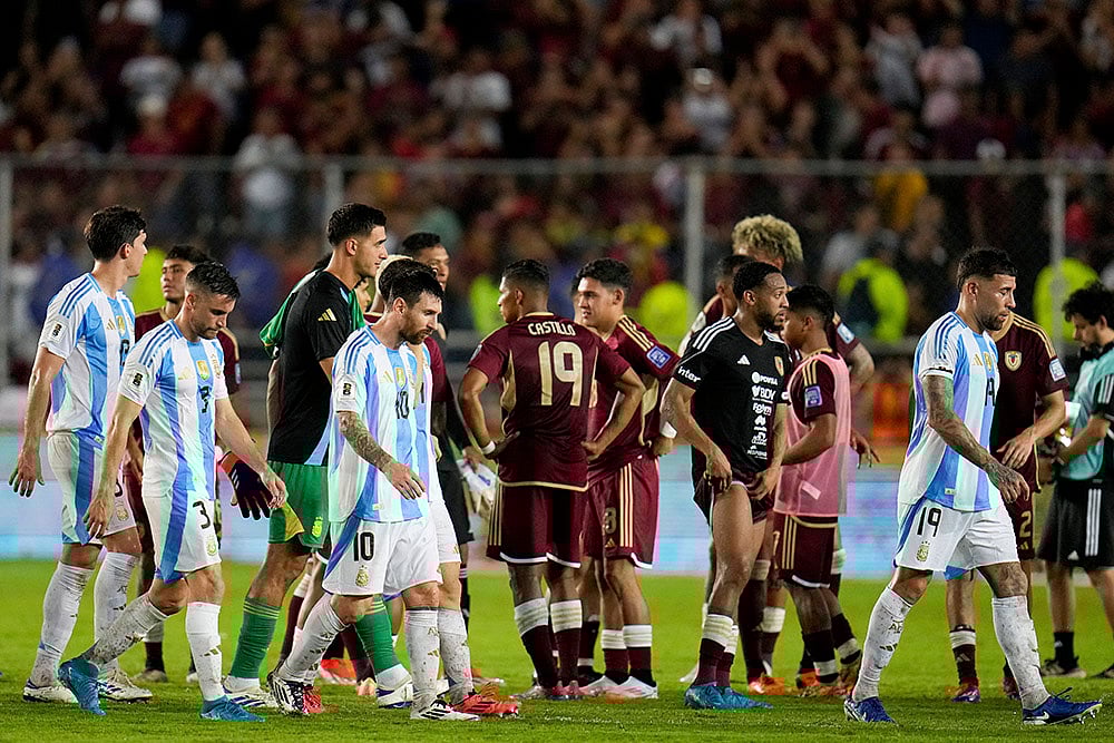 | Photo: AP/Ariana Cubillos : FIFA World Cup 2026 Qualifiers: Argentinas Lionel Messi and teammates walk off the field after draw against Venezuela