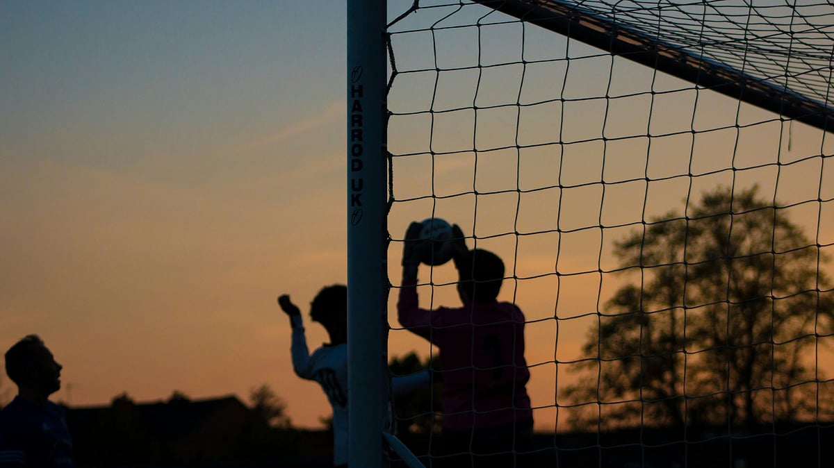 Unsplash : Representative image showing people playing football.