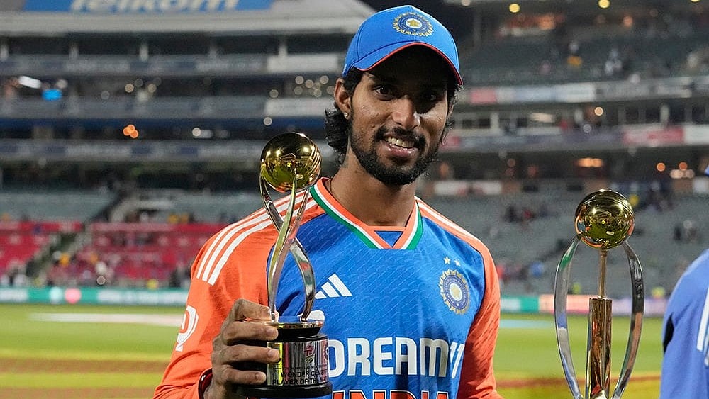 | Photo: AP/Themba Hadebe : Indias Tilak Varma poses with the Player of the Match and Player of the Series trophies