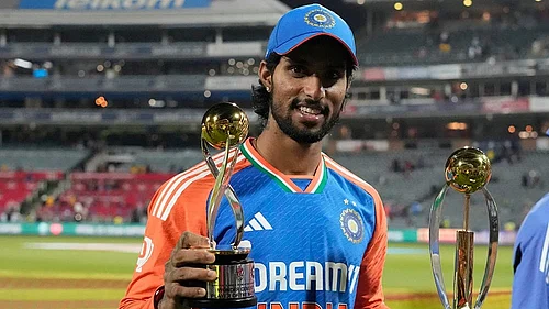 | Photo: AP/Themba Hadebe : Indias Tilak Varma poses with the Player of the Match and Player of the Series trophies