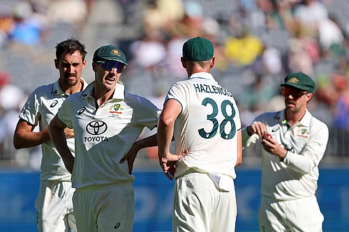 | Photo: AP/Trevor Collens : IND Vs AUS 1st Test, Day 2: Australias captain Pat Cummins, second left, has a chat with teammate Josh Hazlewood