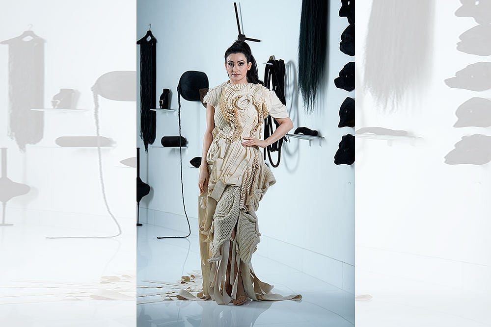 Photo: Vikram Sharma : Standing Tall: Shalini Passi in a Samant Chauhan outfit, inspired by Patna-based artist Rajat Ghosh’s ‘Evolution of Man’ series. She is standing in front of Delhi-based artist Anita Dube’s 1998 artwork ‘The Theatre of Sade’