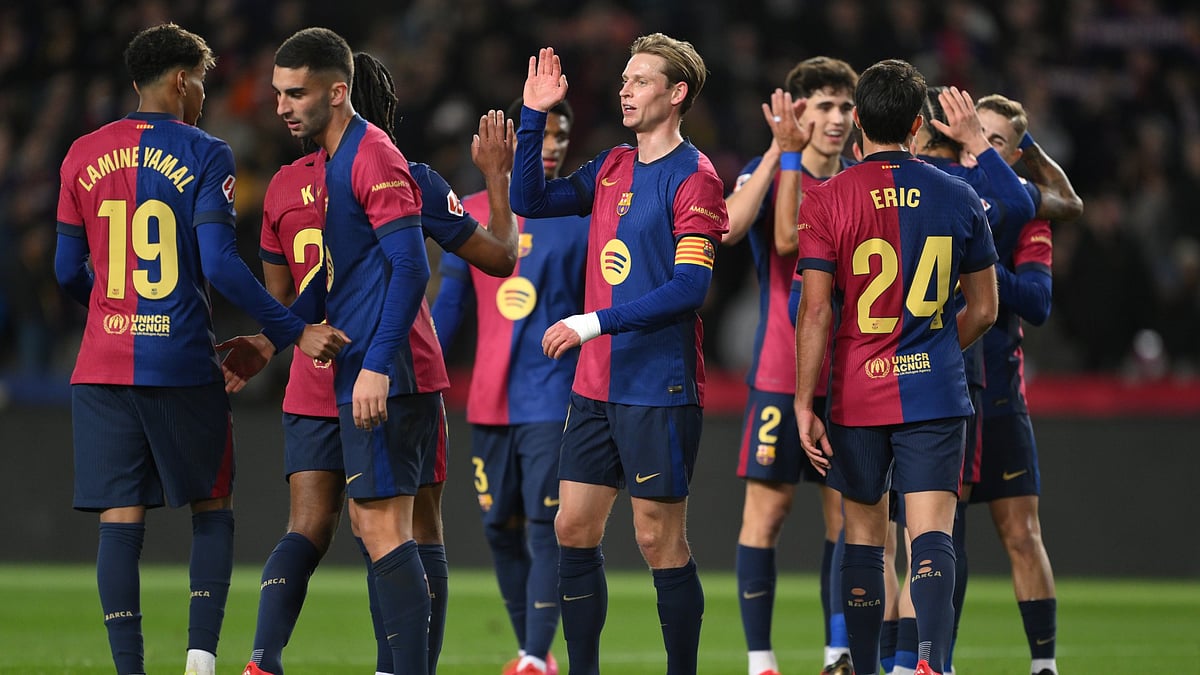 File : FC Barcelona players celebrate after scoring a goal against Valencia in La Liga.