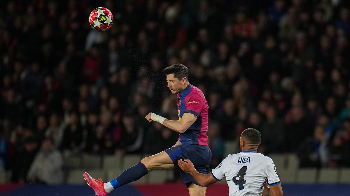 AP Photo/Emilio Morenatti : Barcelona's Robert Lewandowski, top, heads the ball next to Atalanta's Isak Hien during a Champions League opening phase soccer between Barcelona and Atalanta match at the Lluis Companys Olympic stadium in Barcelona.