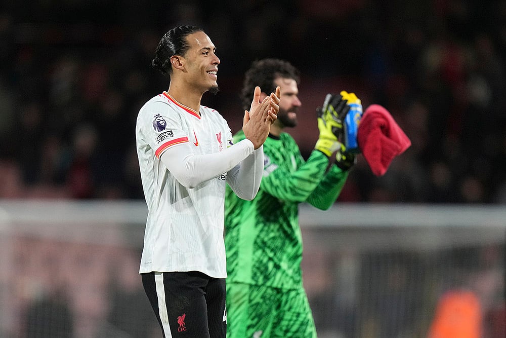 | Photo: AP/Alastair Grant : English Premier League 2024-25: Liverpool's Virgil van Dijk, left, smiles with his teammate goalkeeper Alisson 