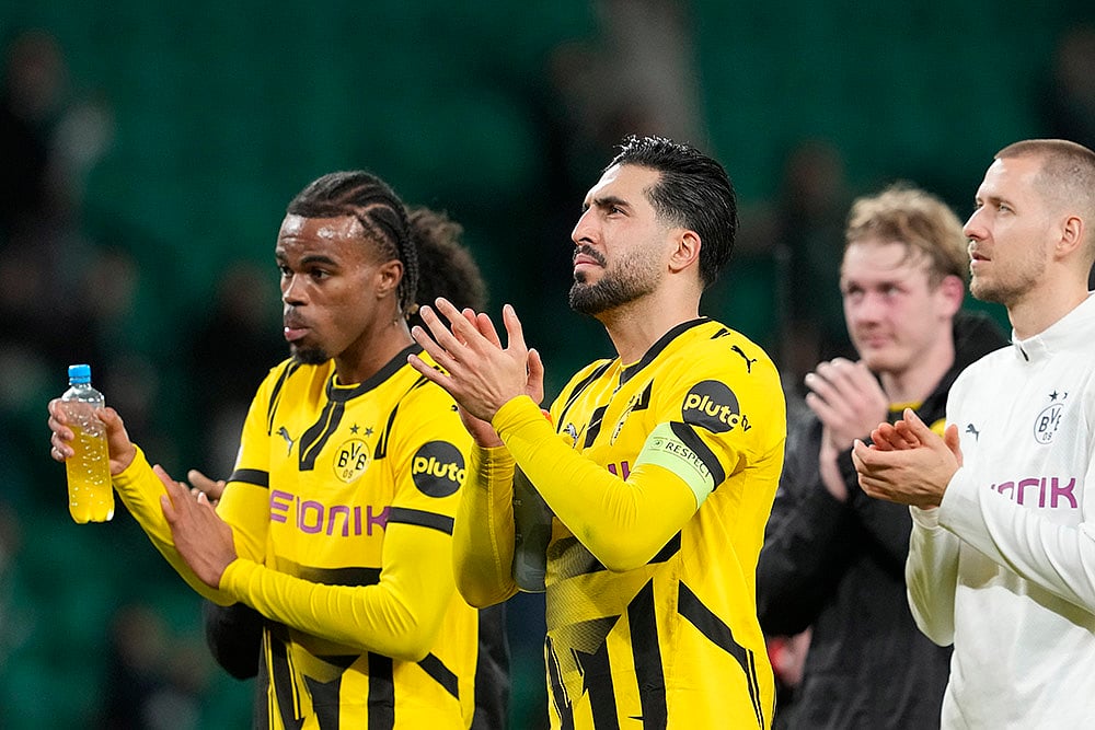 | Photo: AP/Armando Franca : Champions League playoff first leg: Dortmund's Emre Can, centre, applauds fans at the end of the match