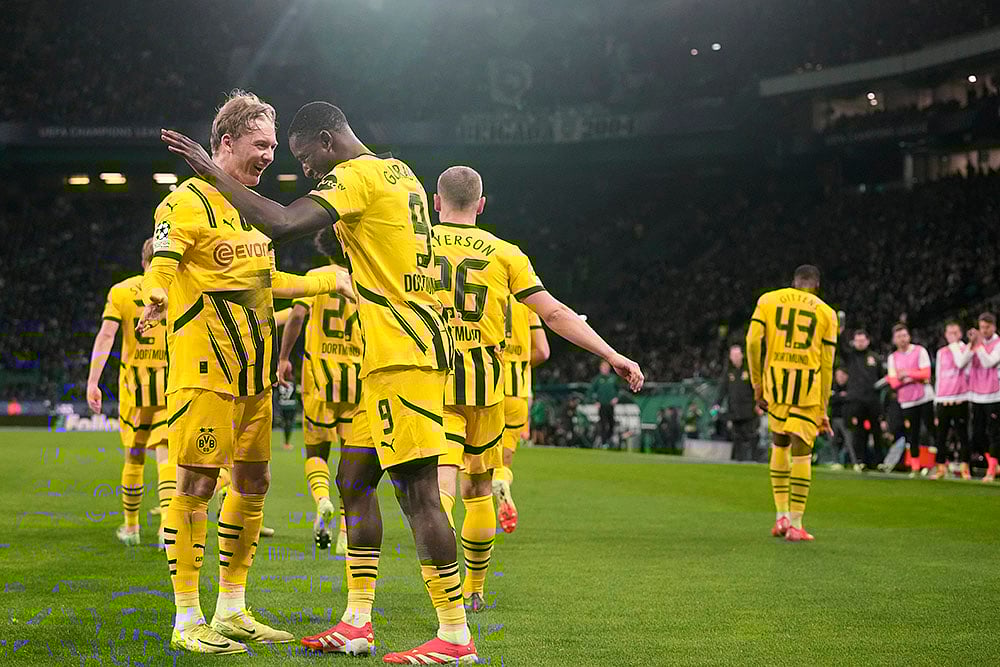 | Photo: AP/Armando Franca : Champions League playoff first leg: Dortmund's Serhou Guirassy celebrates with teammates after scoring his side's opening goal