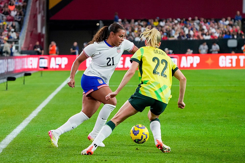 | Photo: AP/Samantha Chow : SheBelieves Cup, Australia vs US: United States forward Michelle Cooper (21) dribbles past Australia defender Charlotte Grant