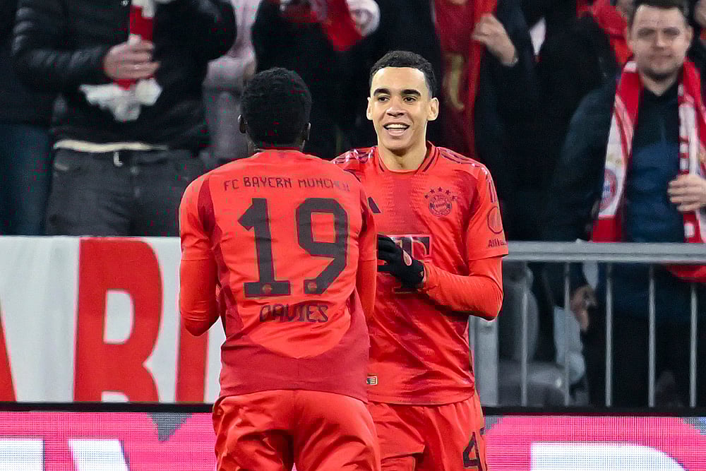 | Photo: Sven Hoppe/dpa via AP : Bundesliga 2024-25, Bayern vs Eintracht: Munich's Jamal Musiala celebrates scoring with Alphonso Davies 