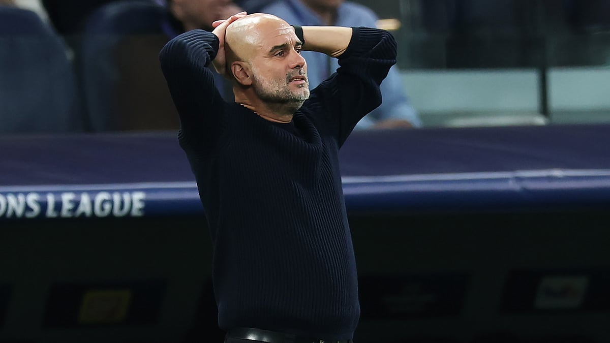 Pep Guardiola looks on during Manchester City's loss to Real Madrid