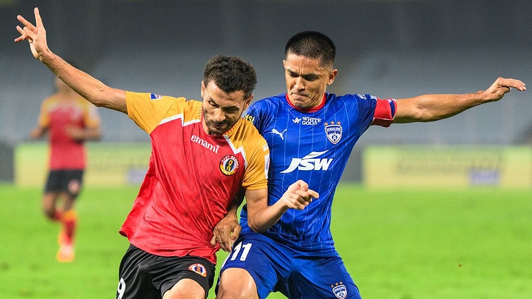 X/Indian Super League : Sunil Chhetri (right) vies for the ball with Mahesh Naorem during the Indian Super League match between East Bengal and Bengaluru FC.