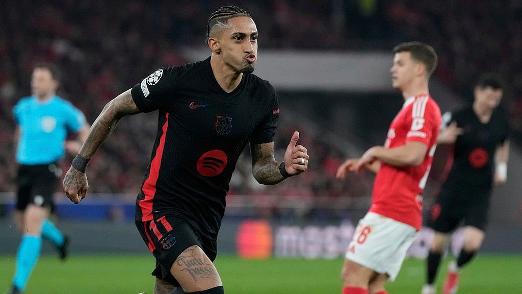 AP/Armando Franca : Barcelona's Raphinha celebrates after scoring his side's opening goal during the Champions League round of 16 first leg soccer match between SL Benfica and FC Barcelona at the Luz stadium in Lisbon, Wednesday.