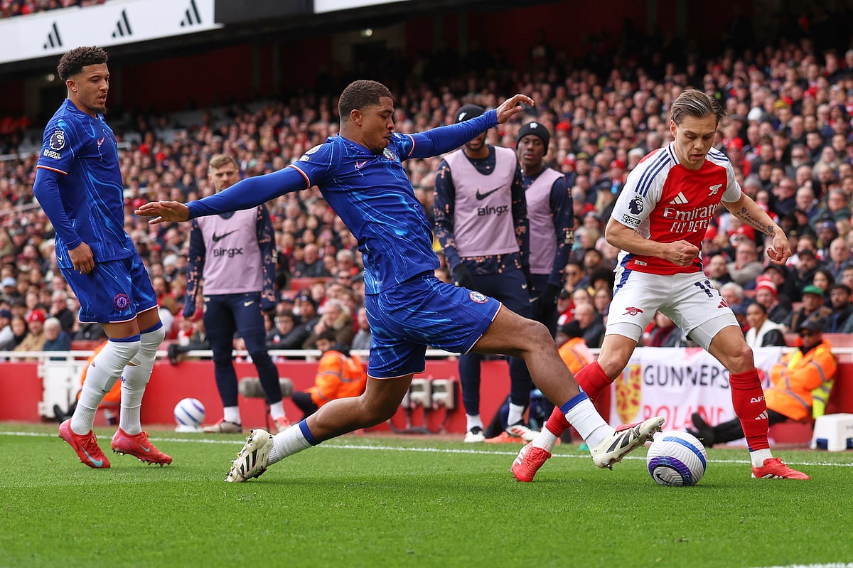 (AP Photo/Ian Walton) : Chelsea's Wesley Fofana, centre, challenges for the ball with Arsenal's Leandro Trossard during the English Premier League soccer match between Arsenal and Chelsea at Emirates stadium in London, Sunday, March 16, 2025. 