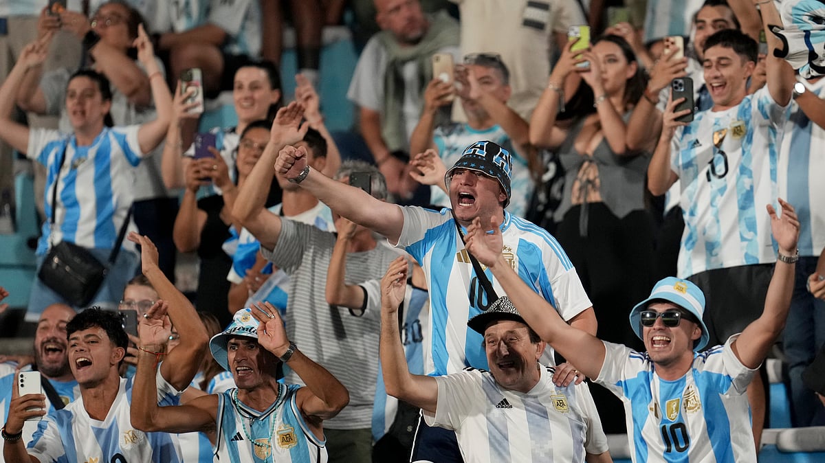 (AP Photo/Matilde Campodonico) : Fans of Argentina react before the start of a qualifying soccer match for the FIFA World Cup 2026 against Uruguay in Montevideo, Uruguay, Friday, March 21, 2025. 