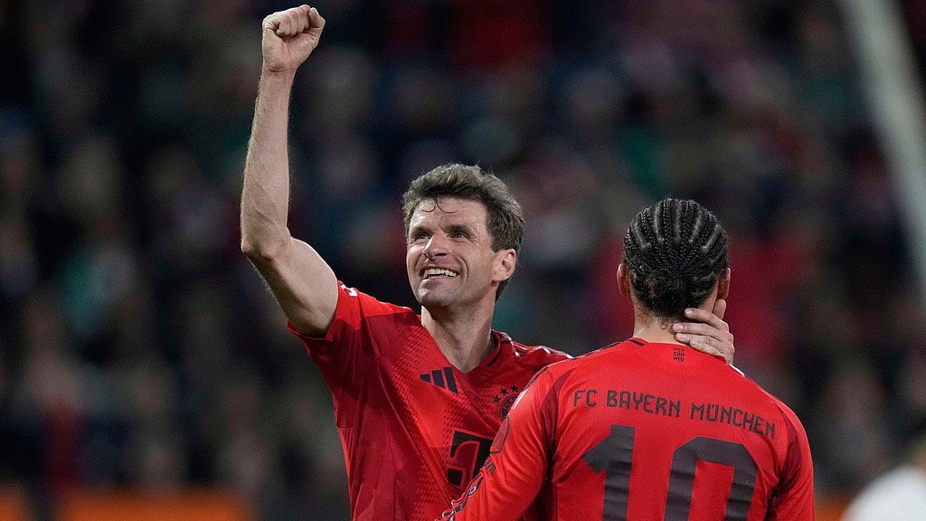 AP/File : Bayern's Thomas Mueller, left, and Leroy Sane celebrate after a goal during the German Bundesliga match between Augsburg and Bayern Munich.