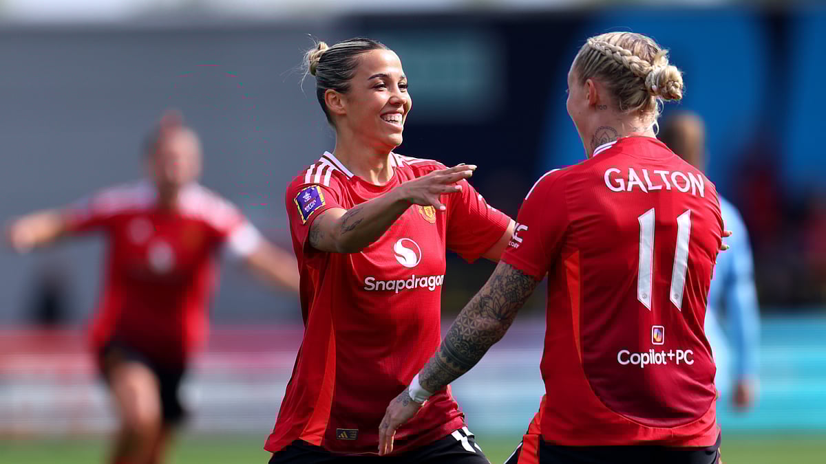 Celin Bizet celebrates her opener on Sunday with Leah Galton (right)