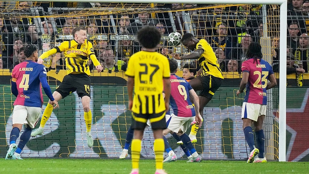 Photo: AP : Dortmund's Serhou Guirassy, second from right, scores his side's second goal during the Champions League quarter-final against Barcelona.