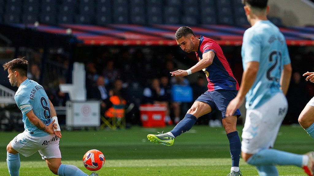 AP/Joan Monfort : Barcelona's Ferran Torres scores his side's opening goal during a Spanish La Liga soccer match between Barcelona and Celta de Vigo at the Lluis Companys Olympic stadium.