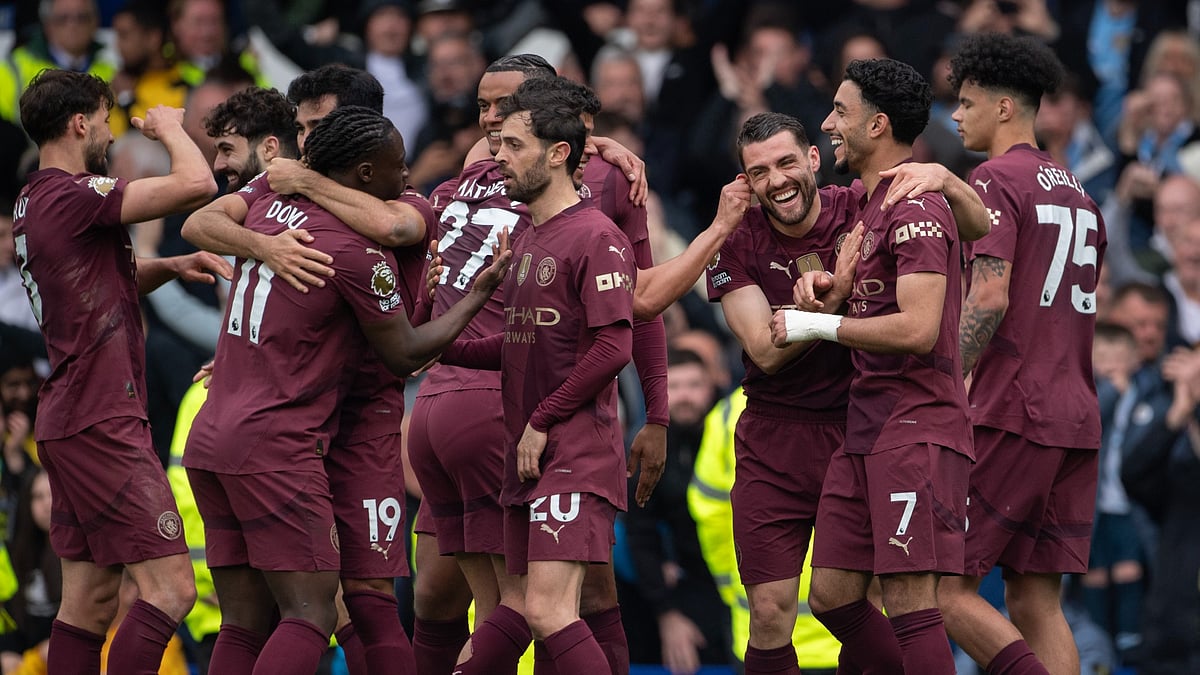 Manchester City players celebrate scoring against Everton.