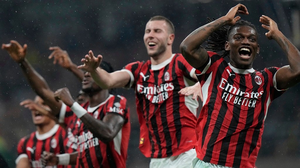 Photo: AP : AC Milan players celebrate their victory over Inter in the Italian Cup semi-final.