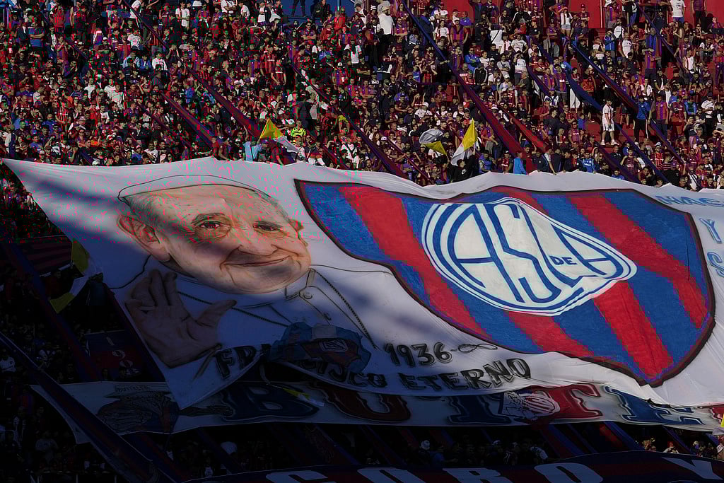 AP : A San Lorenzo banner featuring the late Pope Francis is displayed in the stands, commemorating Francis who was a lifelong supporter of the club, during a local soccer match against Rosario Central in Buenos Aires, Argentina, Saturday, April 26, 2025.