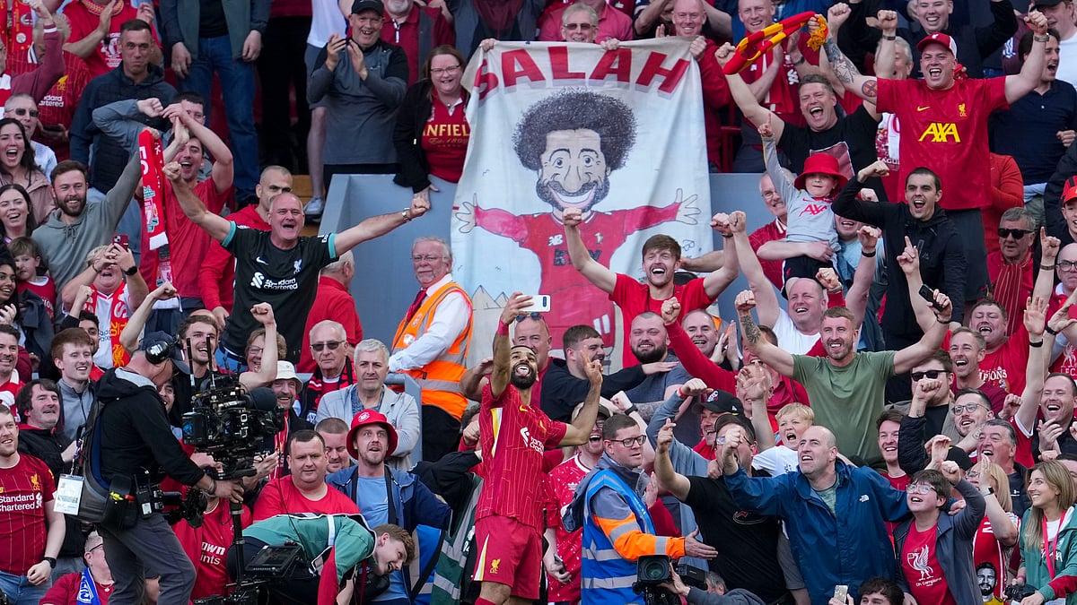 AP Photo/Jon Super : Liverpool's Mohamed Salah takes a selfie with a fan's smartphone as he celebrates after scoring his side's fourth goal during the English Premier League soccer match between Liverpool and Tottenham Hotspur at Anfield in Liverpool.