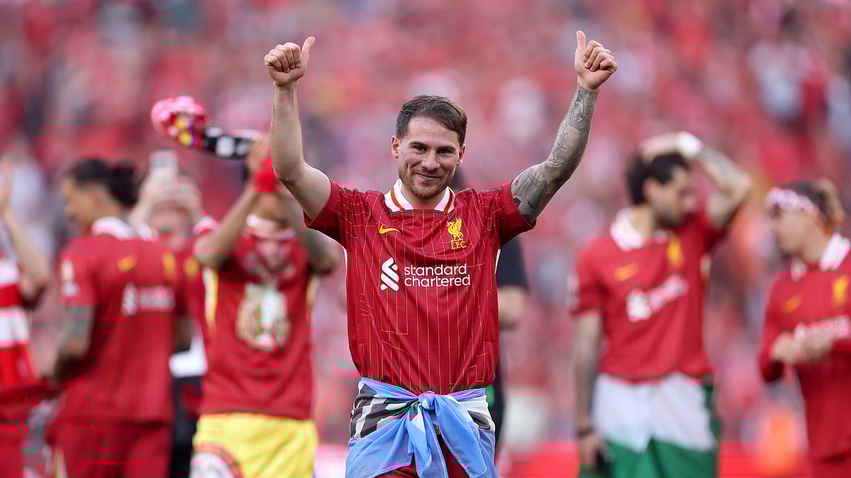 Alexis Mac Allister celebrates Liverpool's Premier League title win.