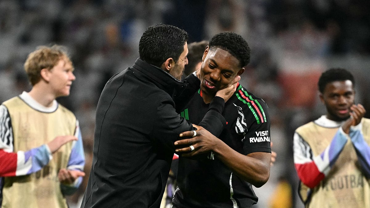 Myles Lewis-Skelly and Mikel Arteta embrace after Arsenal's win over Real Madrid
