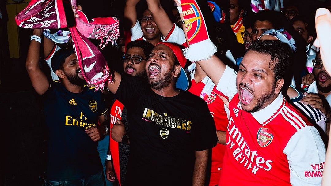 | Photo: X / PLforIndia : Indian fans of Arsenal FC cheer during a Premier League match.