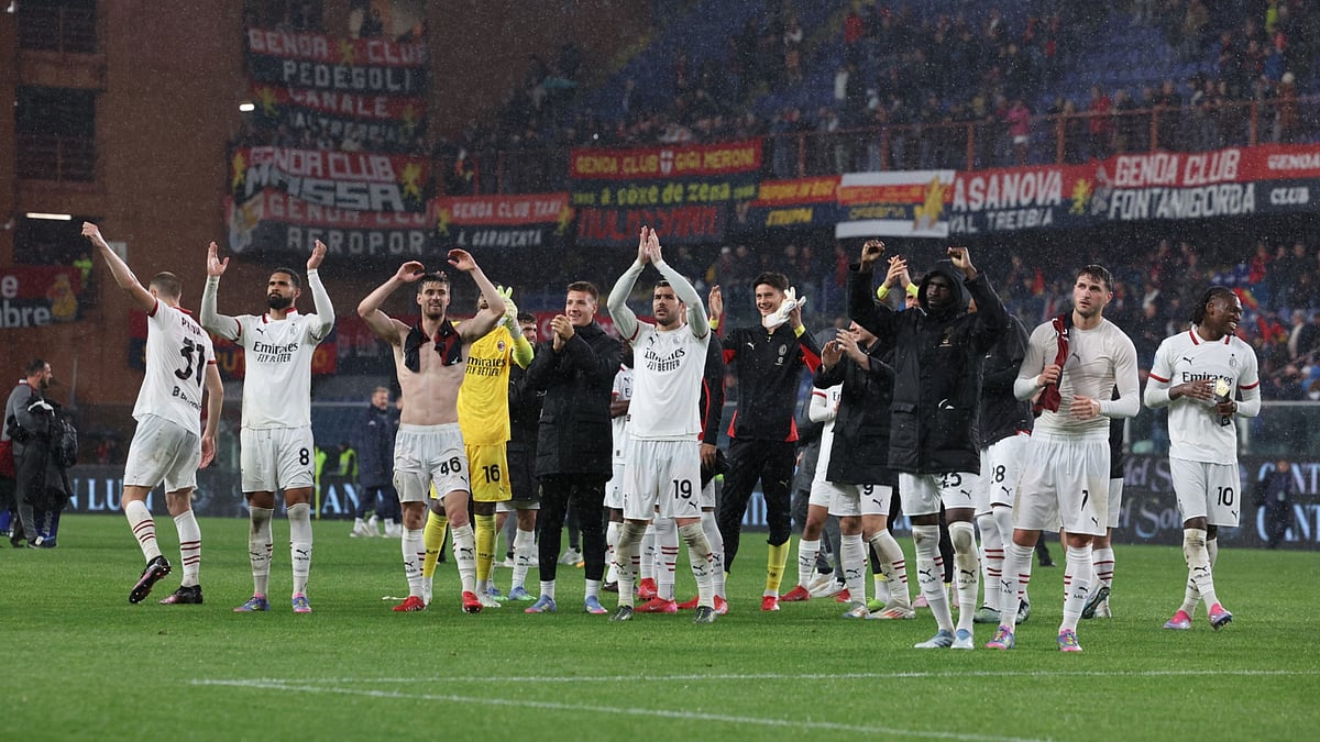 Milan players celebrate at Genoa.
