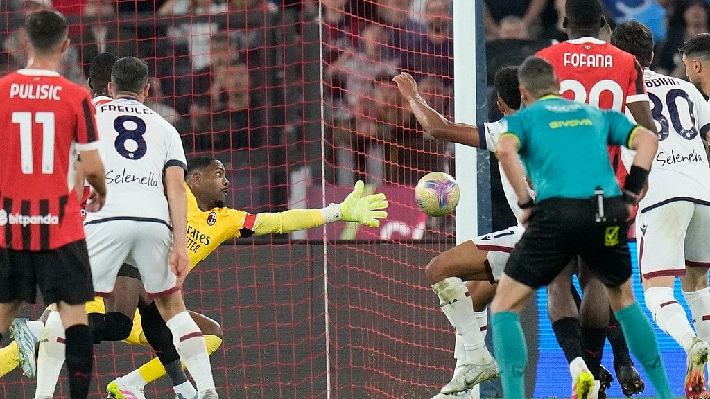 | Photo: AP/Gregorio Borgia : Bologna's Dan Ndoye scores the opening goal past AC Milan's goalkeeper Mike Maignan during the Coppa Italia final.