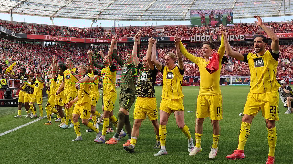 Rolf Vennenbernd/dpa via AP : Borussia Dortmund's players celebrate after their German Bundesliga 2024-25 match against Bayer Leverkusen in Leverkusen on May 11, 2025.