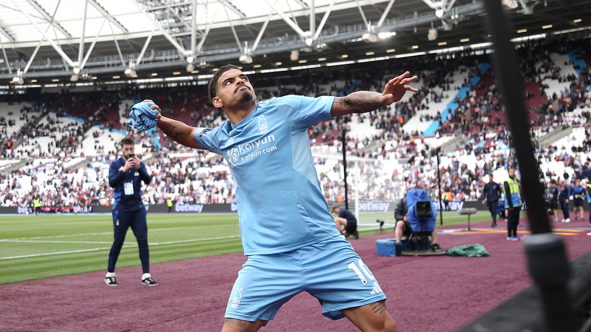Morgan Gibbs-White throws a shirt into the crowd after Nottingham Forest's win