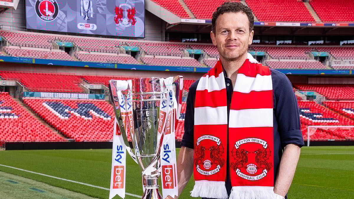 | Photo: leytonorientfc : Former Leyton Orient player Matt Lockwood poses with the EFL League One 2024-25 playoff trophy before the match against Charlton Athletic.