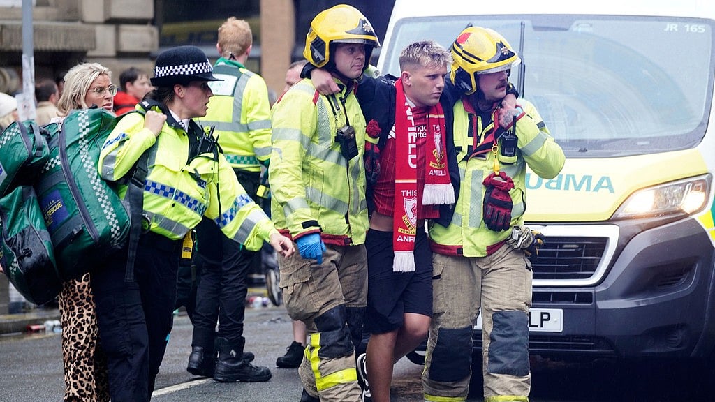 AP : Police and emergency personnel deal with an incident in Liverpool after a car collided with pedestrians during the Premier League winners' parade.