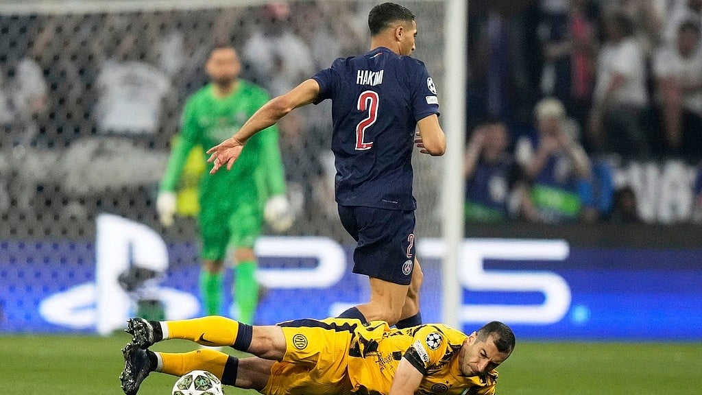 Photo: AP : Inter Milan's Henrikh Mkhitaryan, bottom, falls after challenging for the ball with Paris Saint-Germain's Achraf Hakimi during the Champions League final at the Allianz Arena in Munich, Germany.