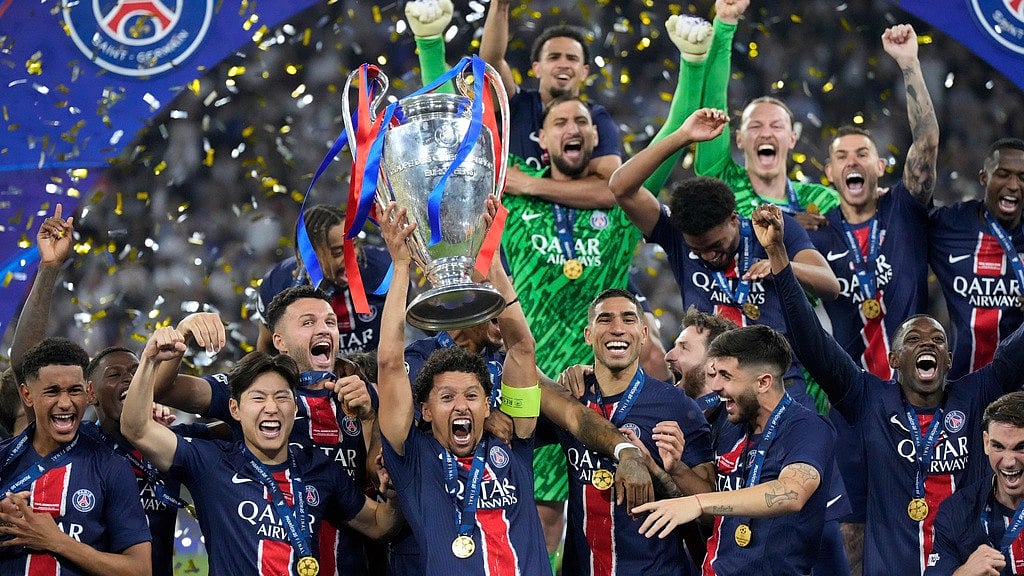 Photo: AP : Paris Saint-Germain players celebrate with the trophy after winning the Champions League final against Inter Milan at the Allianz Arena in Munich, Germany.
