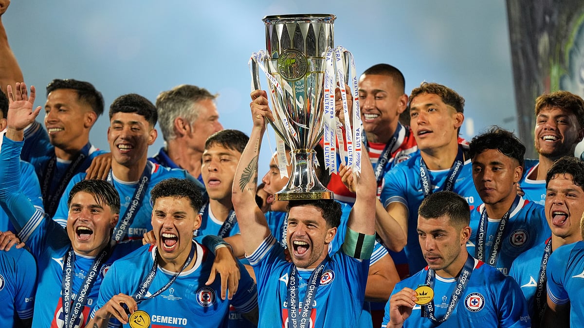 (AP Photo/Fernando Llano) : Ignacio Rivero of Mexico's Cruz Azul lifts the trophy after winning the CONCACAF Champions Cup final soccer match against Canada's Vancouver Whitecaps in Mexico City, Sunday, June 1, 2025. 