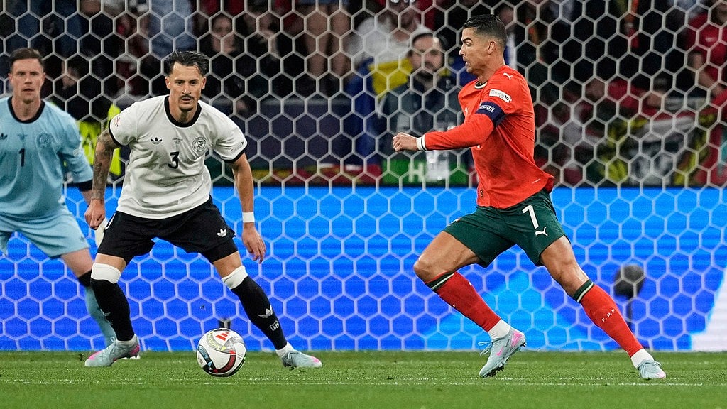 AP : Portugal's Cristiano Ronaldo, right, attempts a shot at goal during the Nations League semifinal soccer match between Portugal and Germany at the Munich Football Arena.