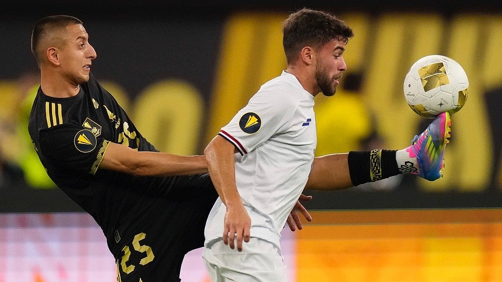 AP/Mark J. Terrill : Mexico forward Roberto Alvarado (25) kicks the ball in front of Dominican Republic midfielder Edison Azcona (13) during the second half of a CONCACAF Gold Cup soccer match Saturday, June 14.