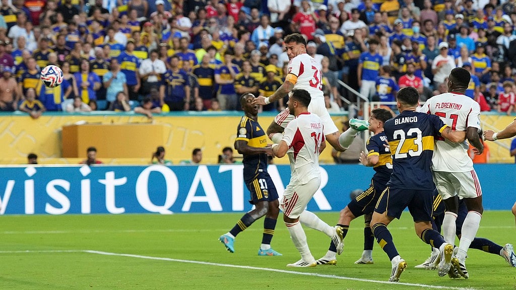 Photo: AP : Benfica's Nicolas Otamendi (30) scores his side's second goal during the FIFA Club World Cup group C match against Boca Juniors in Miami Gardens, Florida.