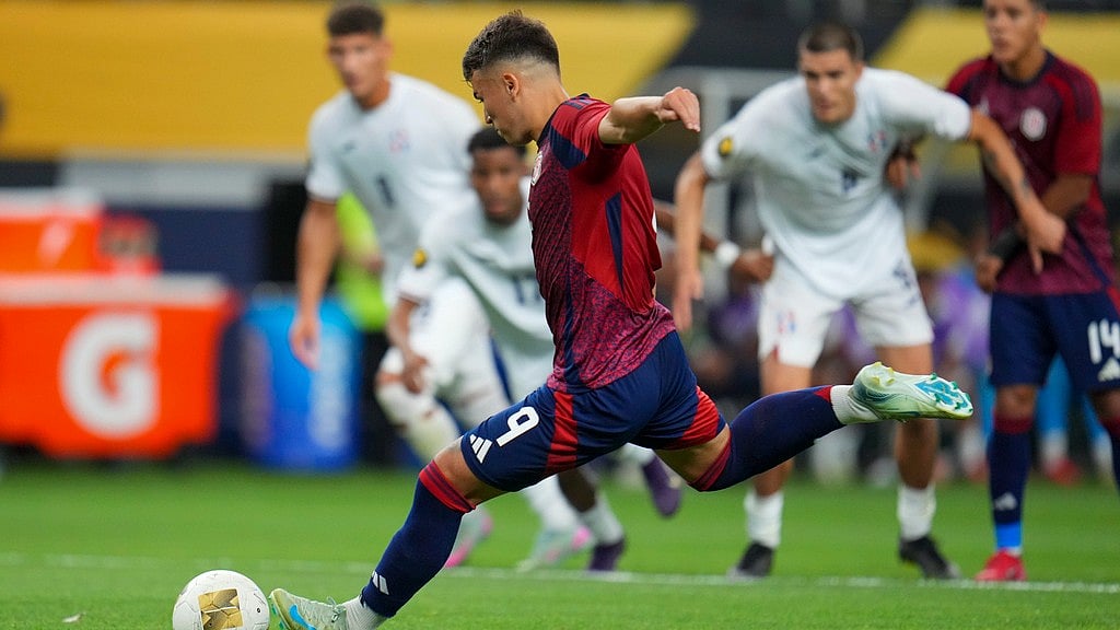 Photo: AP : Costa Rica forward Manfred Ugalde (9) kicks a penalty shot for a goal against the Dominican Republic during their Concacaf Gold Cup match in Arlington, Texas.