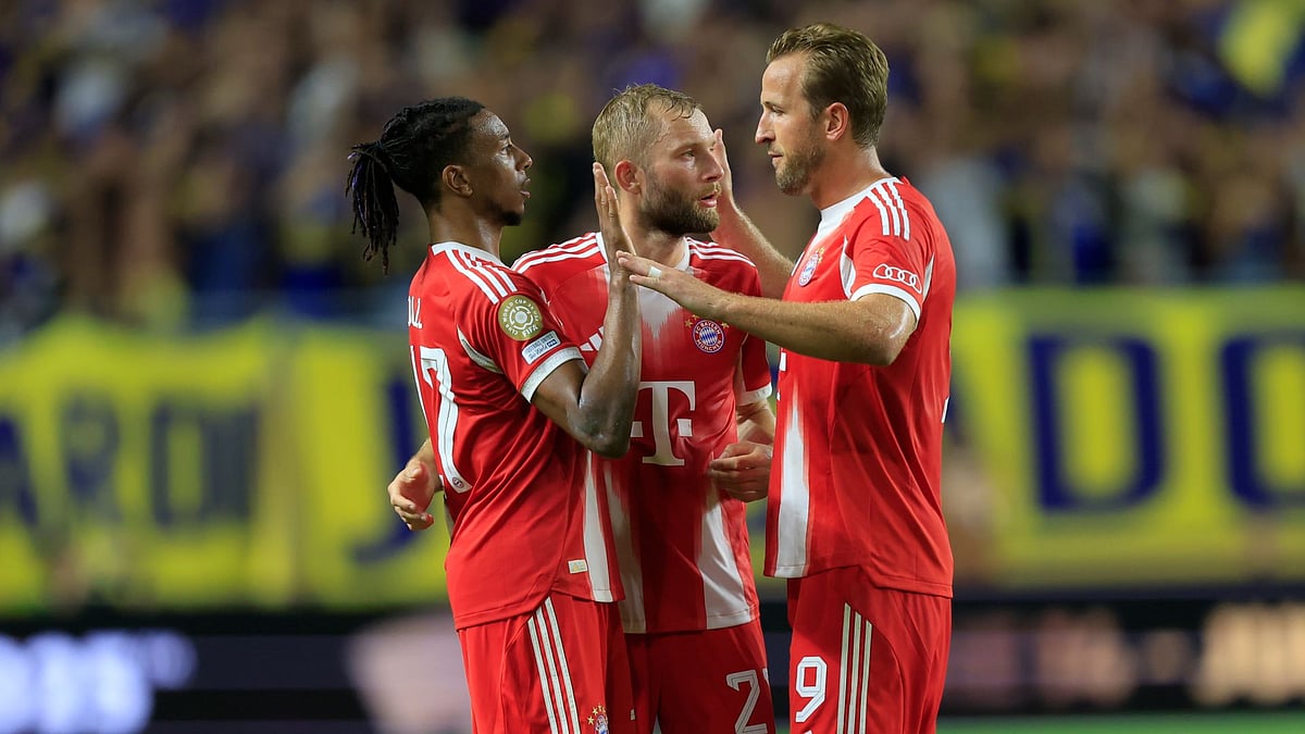 Olise (left) celebrates Bayern's victory with Laimer (centre) and Kane (right)