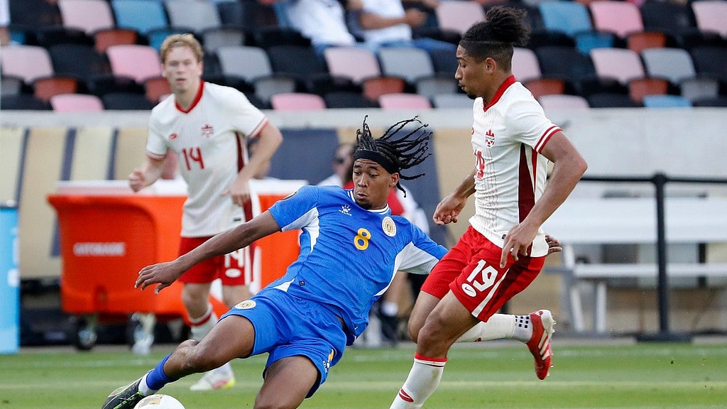 Photo: AP : Curacao's Livano Comenencia (8) slide tackles the ball away from Canada's Nathan Saliba (19) during their Concacaf Gold Cup game in Houston, Texas.