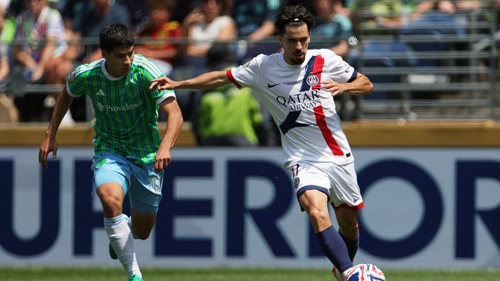 AP : Paris Saint-Germain's Vitinha, right, passes the ball as Seattle Sounders' Obed Vargas looks on during the Club World Cup Group B soccer match between Seattle Sounders and PSG.