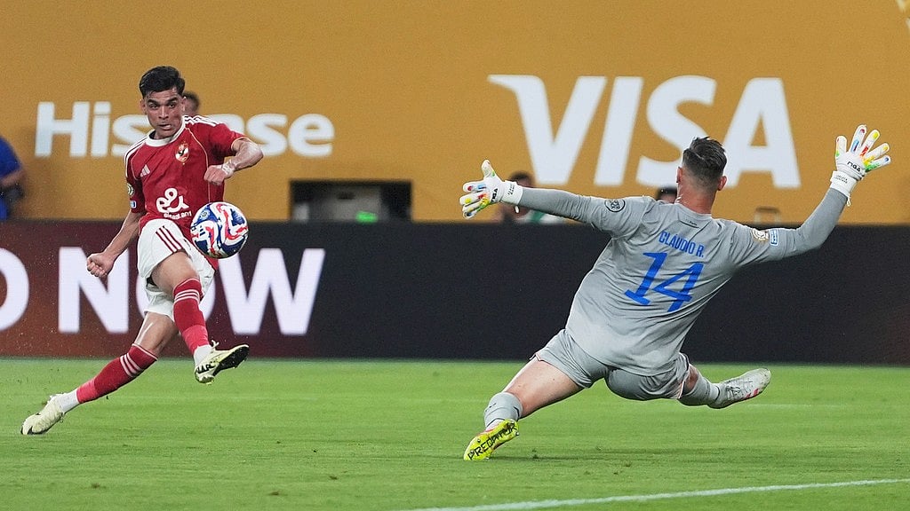 AP/Frank Franklin II : Achraf Bencharki attempts a shot on goal as he kicks the ball past Porto's goalkeeper Claudio Ramos, right, during the Club World Cup Group A soccer match between FC Porto and Al Ahly.