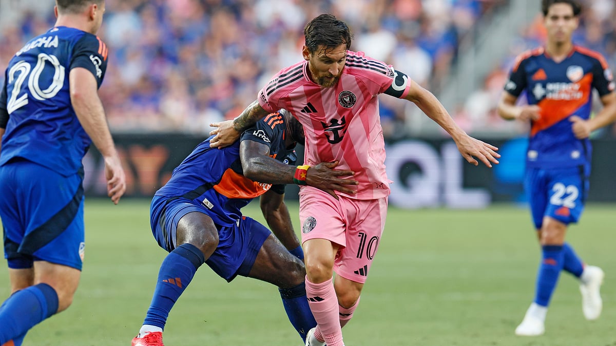 (AP Photo/Jay LaPrete) : Inter Miami's Lionel Messi, right, keeps the ball away from FC Cincinnati's Tah Brian Anunga during the first half of an MLS soccer match, Wednesday, July 16, 2025, in Cincinnati. 